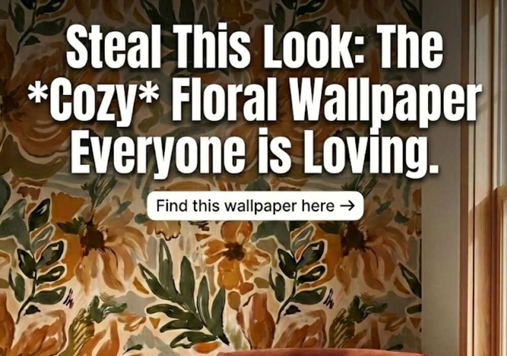 Cozy reading nook featuring a rust orange velvet armchair with a chunky knit blanket, set against a trending floral wallpaper accent wall in earthy mustard and green tones. Rustic wooden side table with coffee and books. Text overlay reads: Steal This Look.